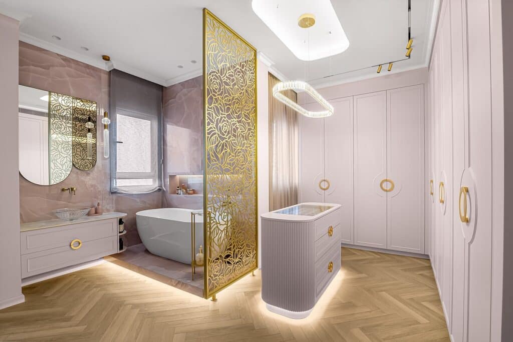 חדר אמבטיה וחדר ארונות מעוצבים בגווני ורוד ולבן, עם אמבטיה, מראה, ארונות בגדים ומחיצה דקורטיבית מזהב.